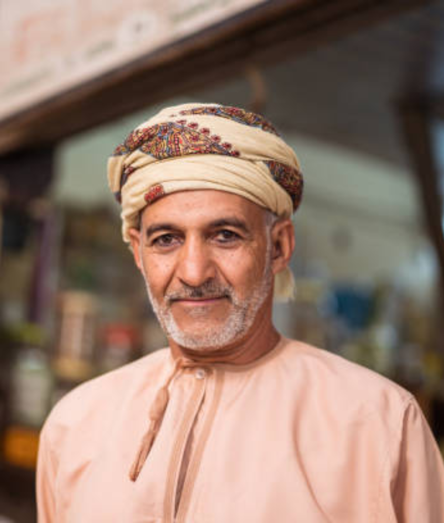 Salim A., Architect, in a cream patterned turban and peach dishdasha