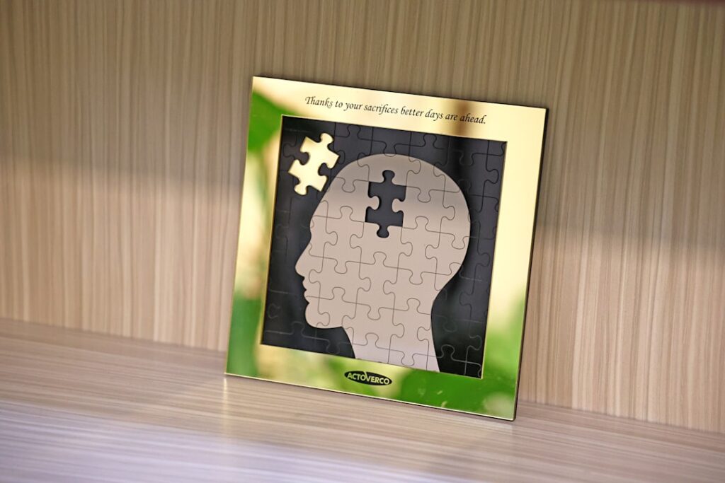 Framed puzzle in the shape of a human head with some pieces missing