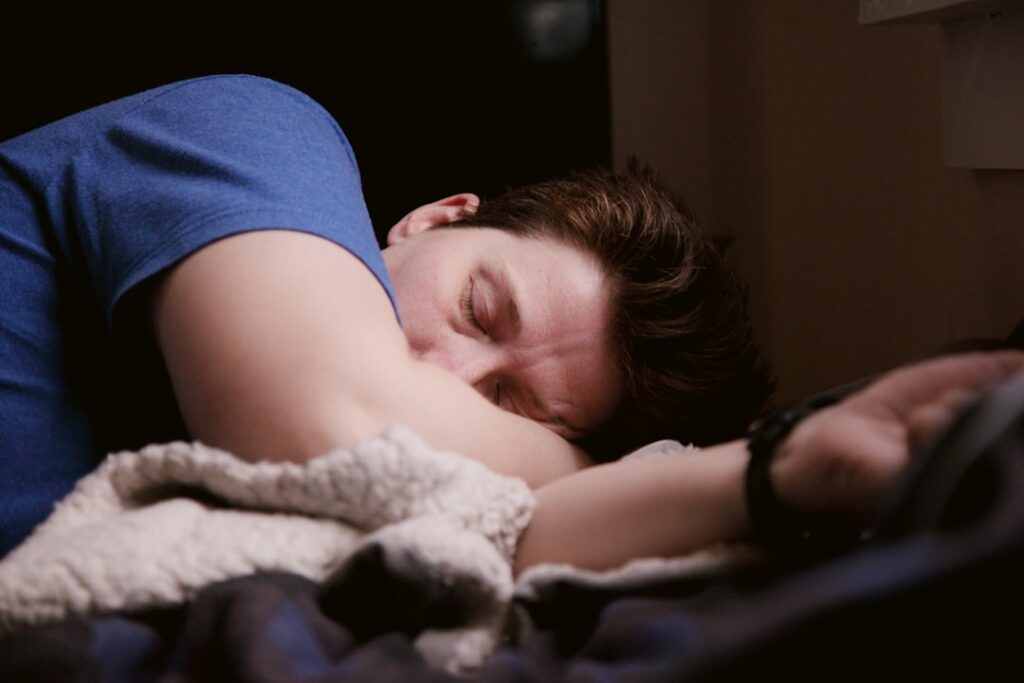 Man asleep with his head resting on his arm